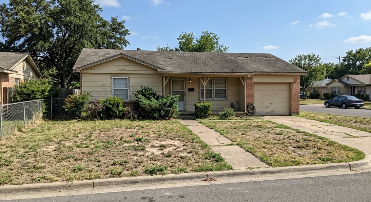 Dated ranch house exterior before remodel, photographed from the street
